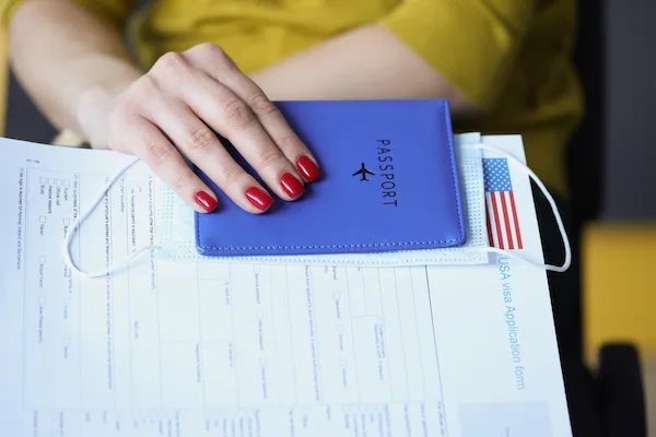 Female hand holding medical American visa