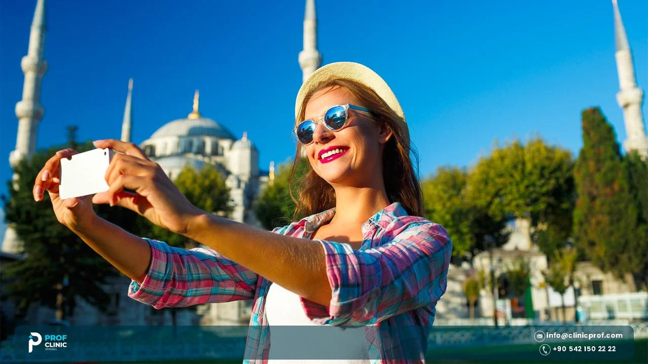 Tourist in sunglasses taking a selfie in front of a mosque with minarets in Istanbul